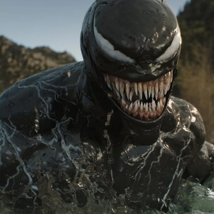 Venom smiles toothily in a still image from the movie Venom: The Last Dance.