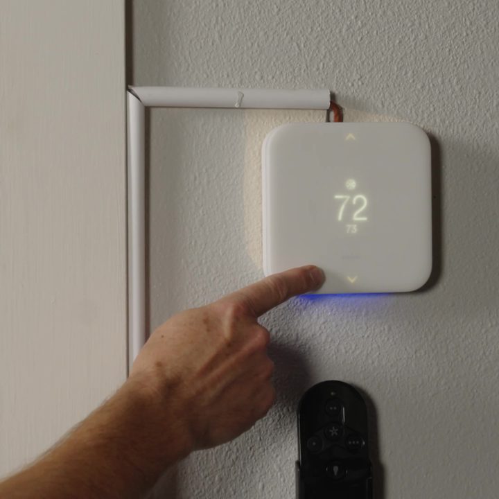 The Vivint Smart Thermostat mounted on a wall.