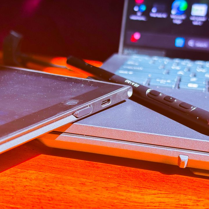 Wacom Movink tablet and stylus atop laptop.