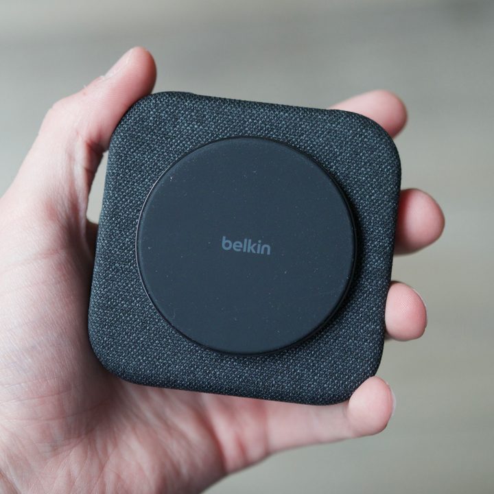 Someone holding Belkin's charging pad, folded up.