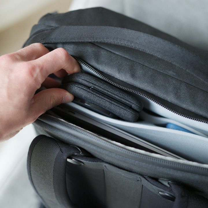 Someone putting the Belkin Travel Pad into a backpack.