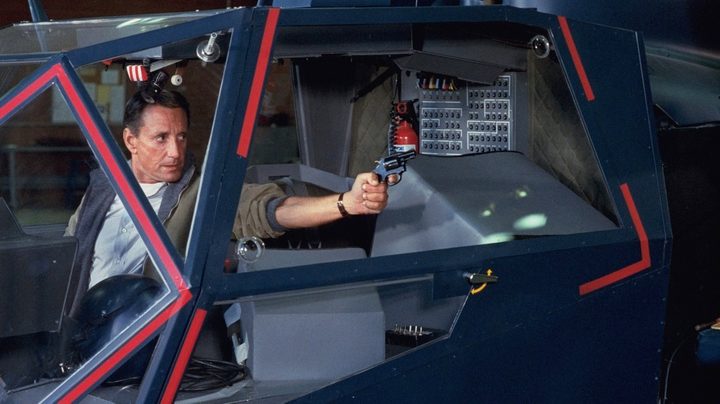 A man aims a gun in Blue Thunder.