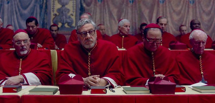 A group of cardinals sit together in Conclave.