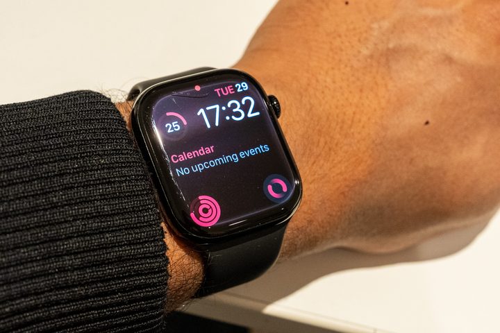 Damaged Apple Watch Series 10 on an arm that's wresting on a table with the display on