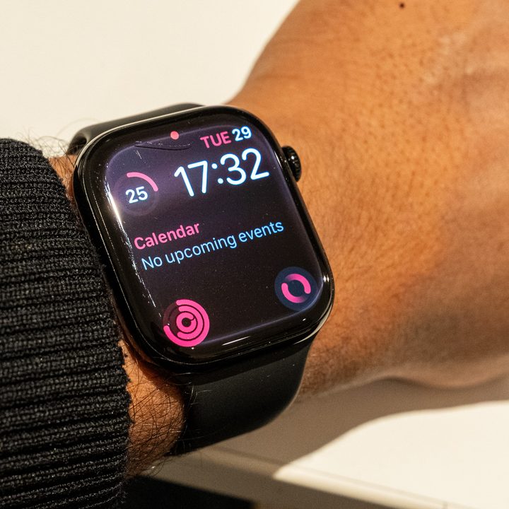 Damaged Apple Watch Series 10 on an arm that's wresting on a table with the display on