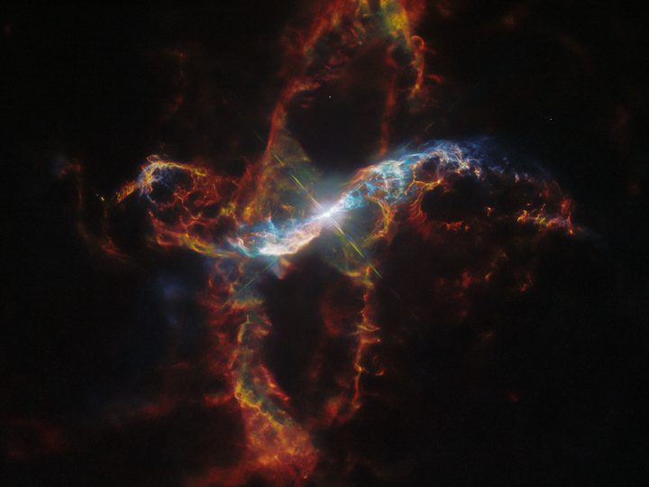 This image features R Aquarii, a symbiotic binary star that lies only roughly 1,000 light-years from Earth in the constellation Aquarius. This is a type of binary star system consisting of a white dwarf and a red giant that is surrounded by a large, dynamic nebula.