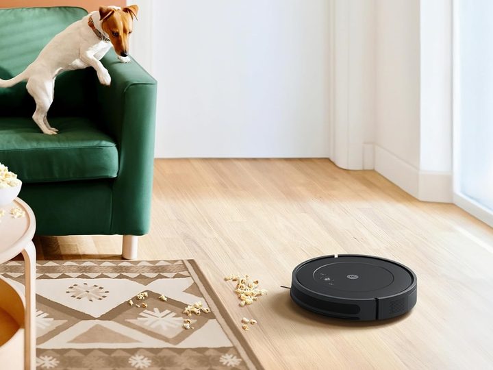 The iRobot Roomba Vacuum and Mop Combo Y0140 cleaning up popcorn on the floor.