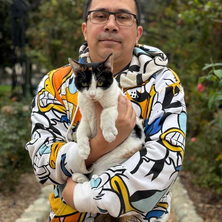 Portrait of man and cat taken with iPhone 16 Pro.
