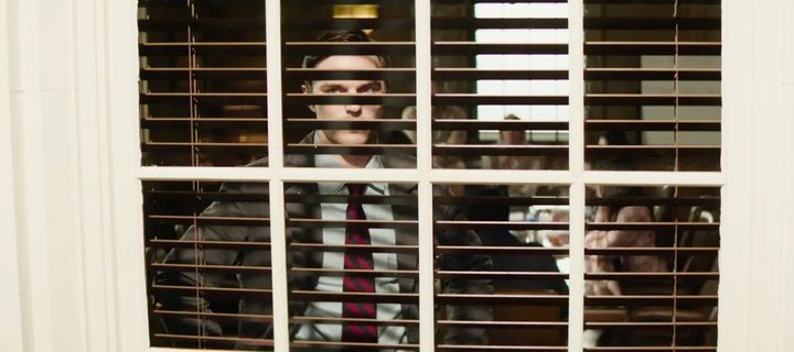 A man looks through blinds in Juror No. 2.