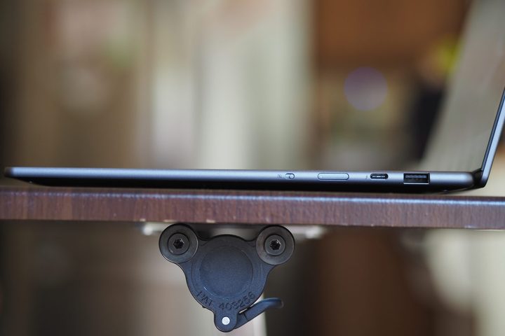 Lenovo Yoga Slim 7i Aura Edition side view showing ports and lid.