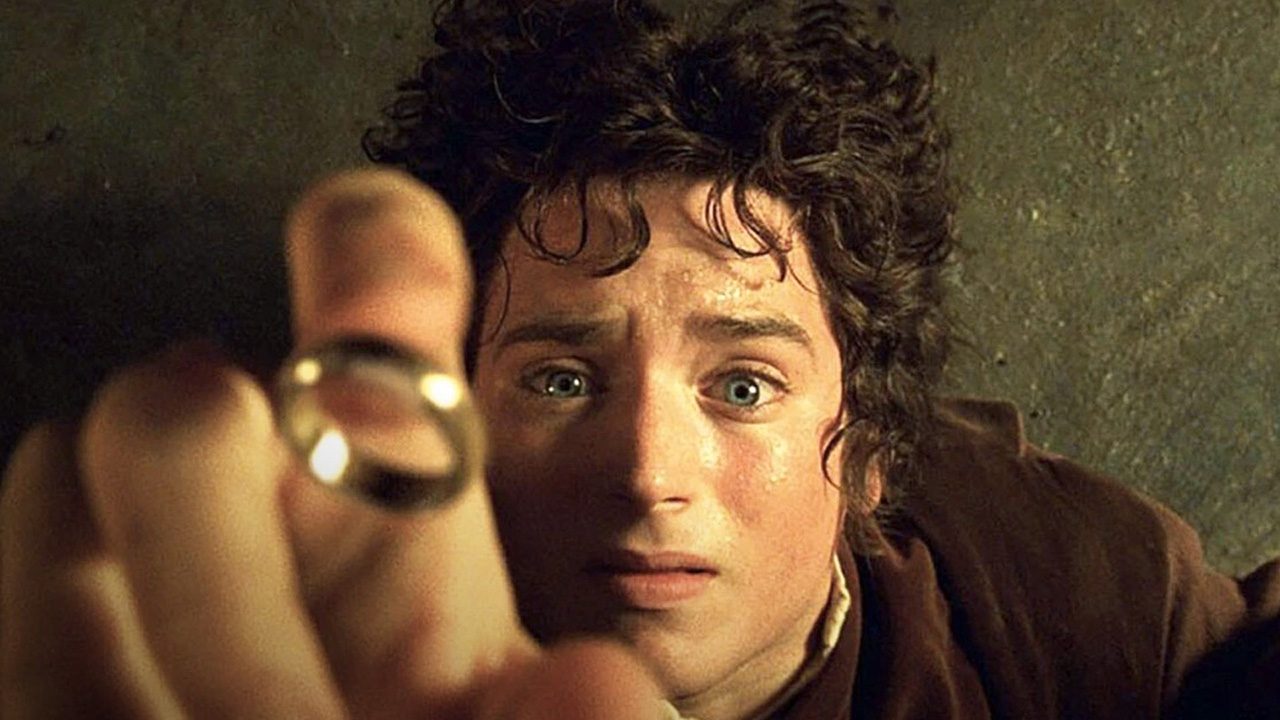 Frodo lying on the ground looking terrified as the One Ring flies above him in "Lord of the Rings: The Fellowship of the Ring."