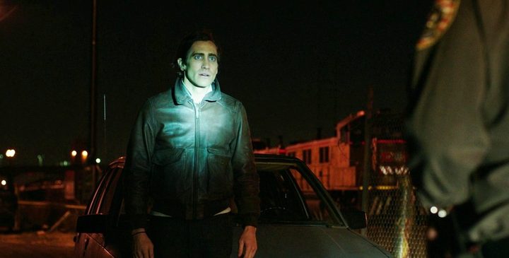 A cop shins a light on a man in Nightcrawler.