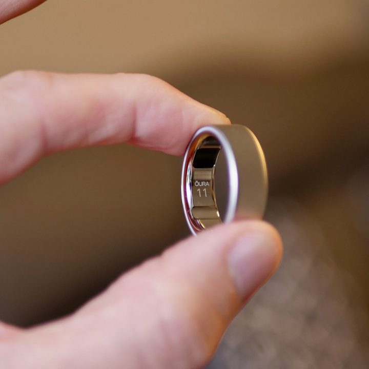 A person holding the Oura Ring 4.
