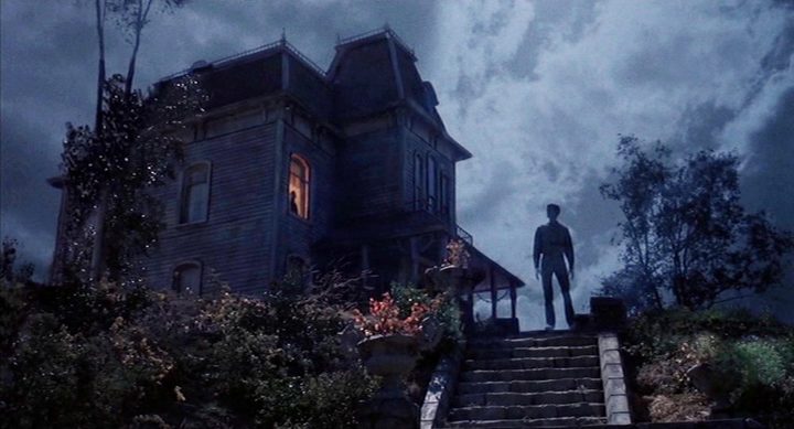 A man stands in front of a house in Psycho II.