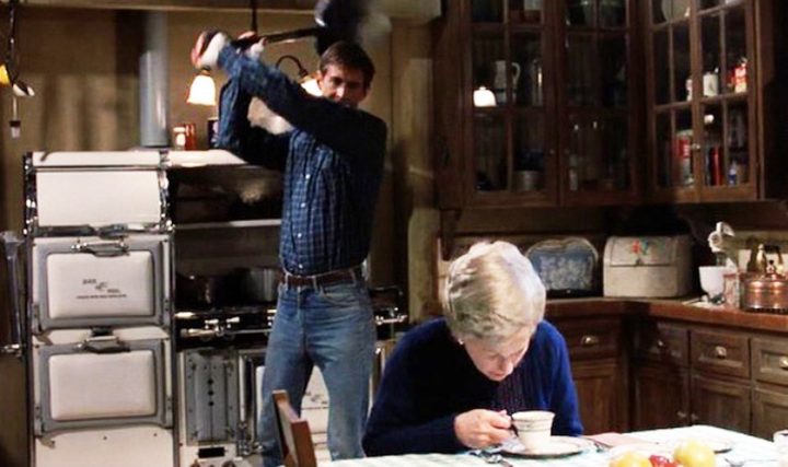 Norman raises a shovel at an old lady in Psycho II.