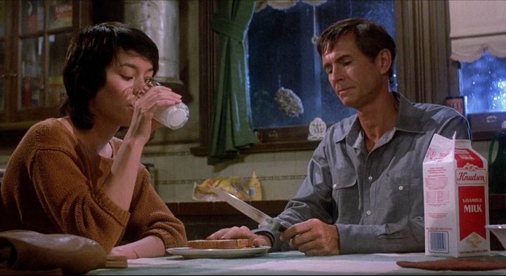 Two people at a table in Psycho II.