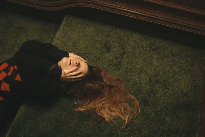 A woman lies on the ground in Saint Maud.