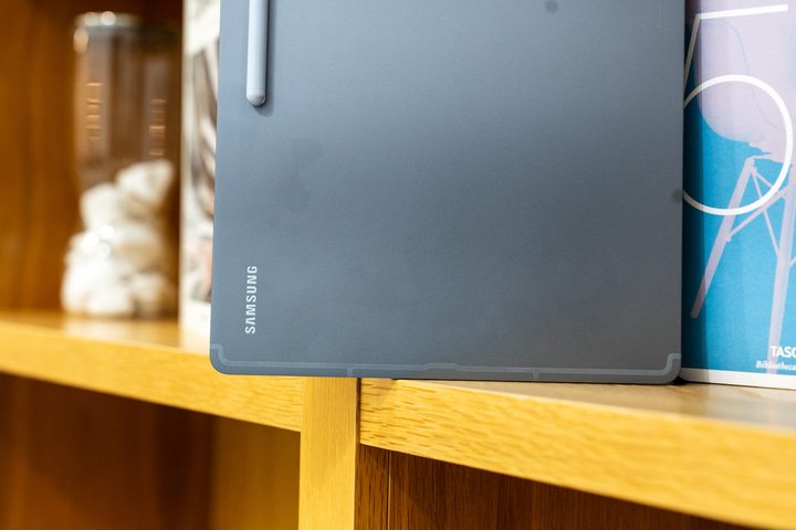 Samsung Galaxy Tab S10 Ultra on a bookshelf.