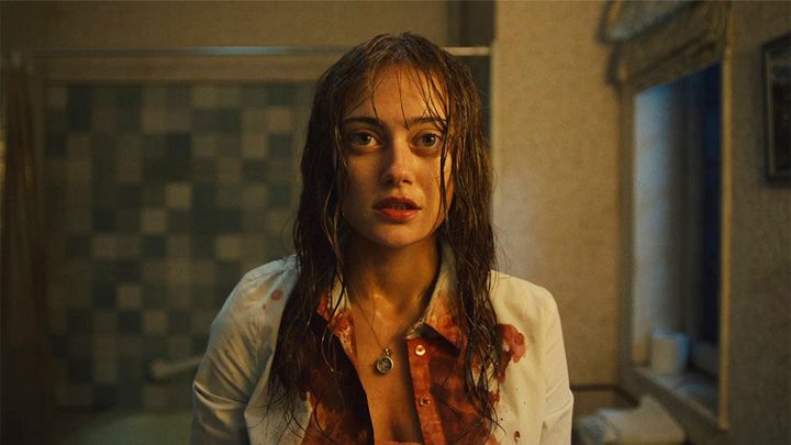 Ella Purnell staring into the camera, disheveled and covered in blood in Sweetpea.