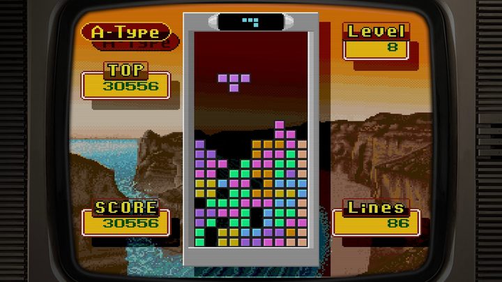 A Tetris game in Tetris Forever. It's on an orange cliffside scene.