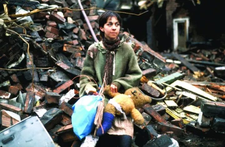 A woman sits in debris in Threads.