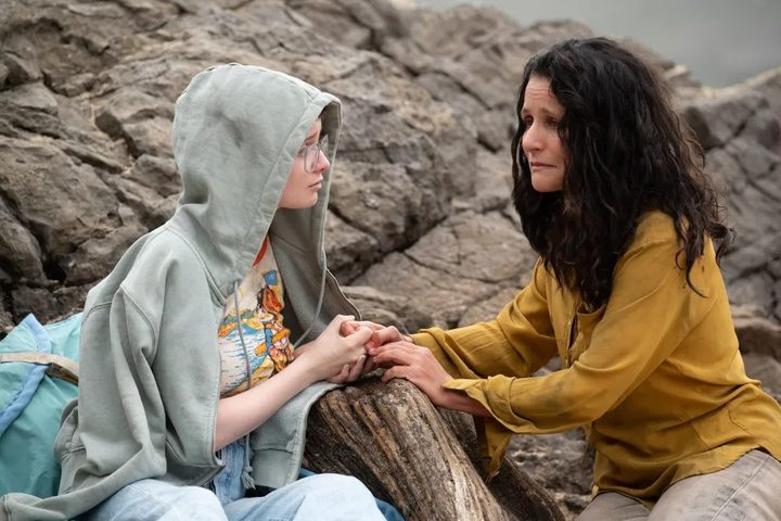 A mother holds her daughter's hands in Tuesday.