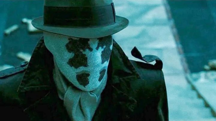Rorschach stands in a street in Watchmen.