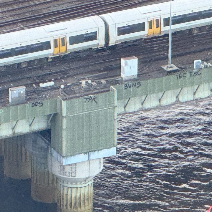 Photo taken at 25x zoom on the iPhone 16 Pro showing graffiti on the side of a bridge in London.