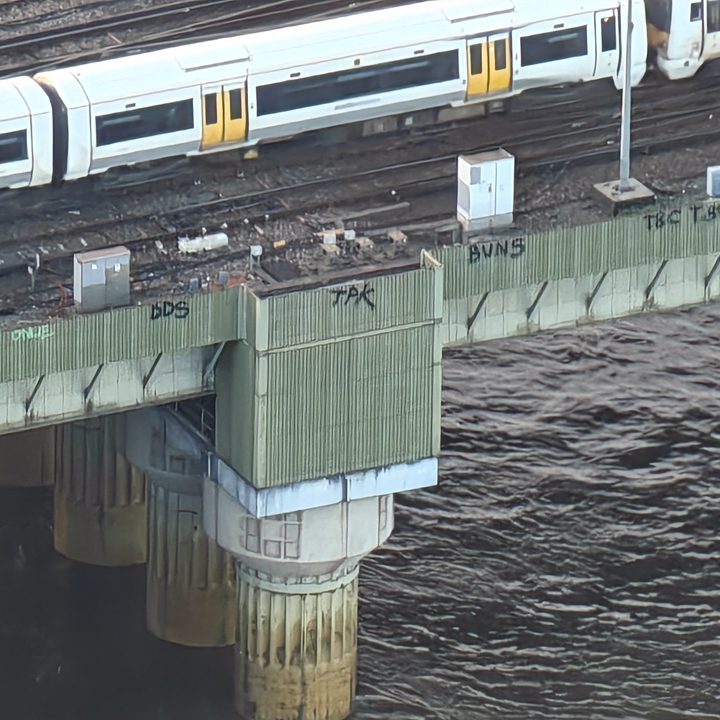 Photo taken at 30x zoom on the Oppo Find X7 Ultra showing graffiti on the side of a bridge in London.