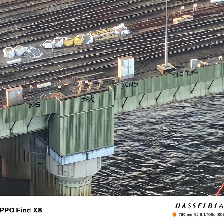 Photo taken at 30x zoom on the Oppo Find X8 showing graffiti on the side of a bridge in London.