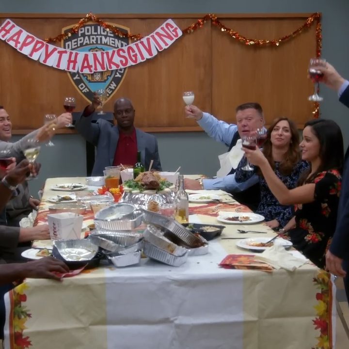 The cast of "Brooklyn Nine-Nine" having a Thanksgiving toast.