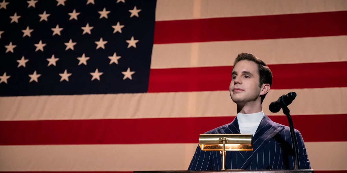 Ben Platt speaks in front of a flag in The Politican