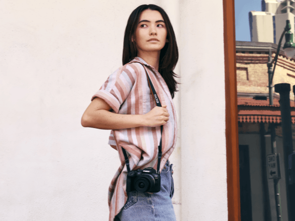 Canon EOS R10 worn on hip by photographer