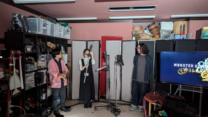 Hideki Hosoi, Wakana Kuroiwa, and Takeshi Kitamura show off instruments created for Monster Hunter Wilds.