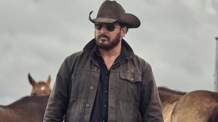 A cowboy stands and stares.