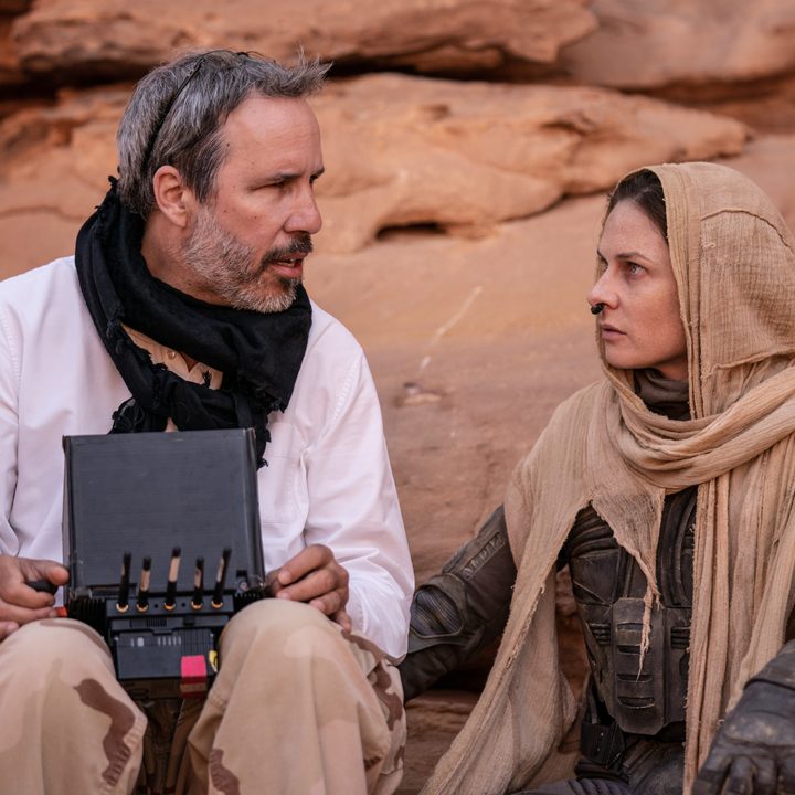 Denis Villeneuve sitting with Rebecca Ferguson on the set of "Dune: Part Two."