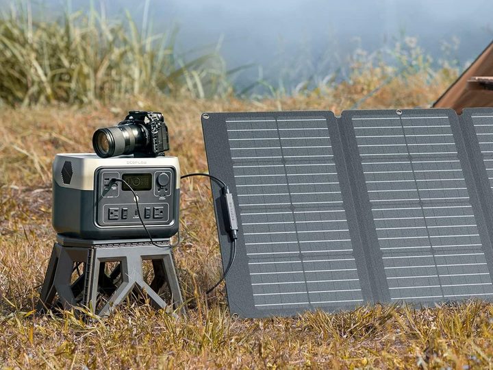 The EcoFlow River 2 Max solar generator charging outdoors using its solar panel.