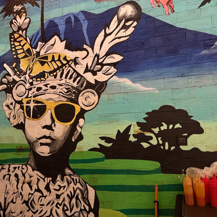 A photo of a mural at Naughty Nuri's BBQ in Bali captured on the iPhone 16 Pro