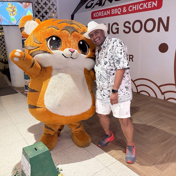 A photo of the author and a big cuddly mascot captured on the iPhone 16 Pro