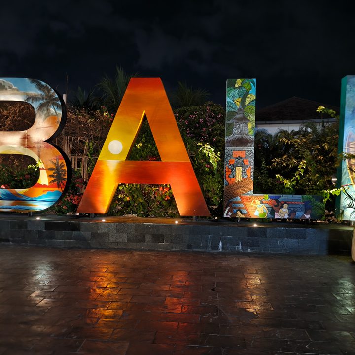 A colorful lit up sign saying Bali captured on the Find X8 Pro