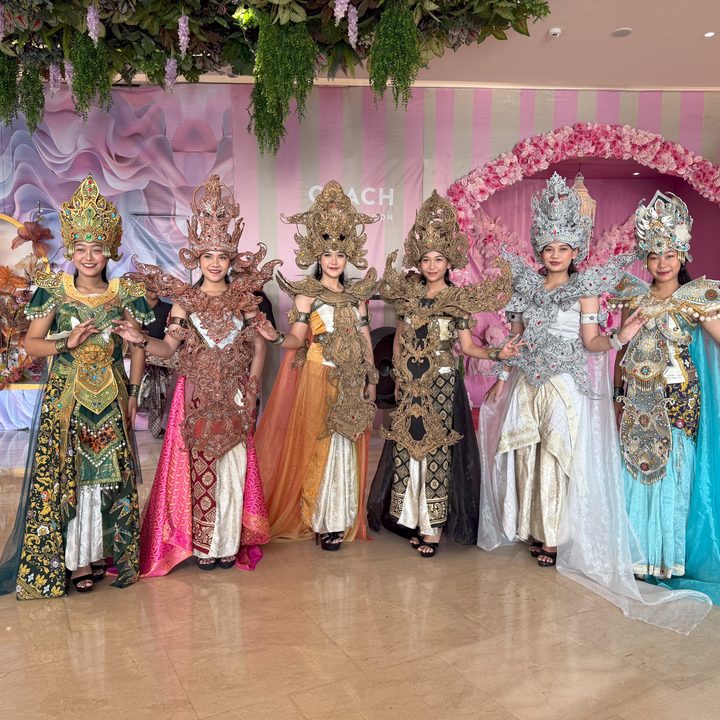 Six women dressed up in a performance captured on the iPhone 16 Pro