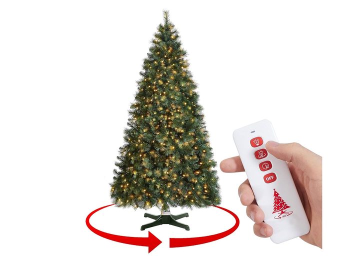 The GREATDAY 7 ft Artificial Pre-Lit Rotating Christmas Tree with its remote.