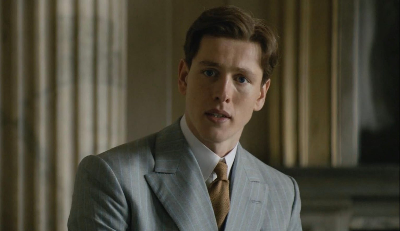 Harris Dickinson looks concerned and stares.