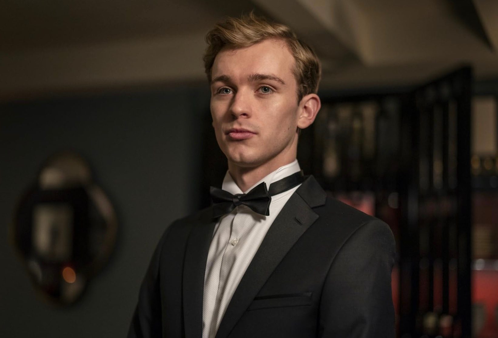 A man in a suit looks and stares.