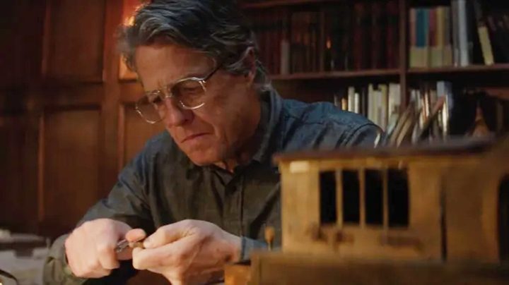 A man makes something at his desk in Heretic.