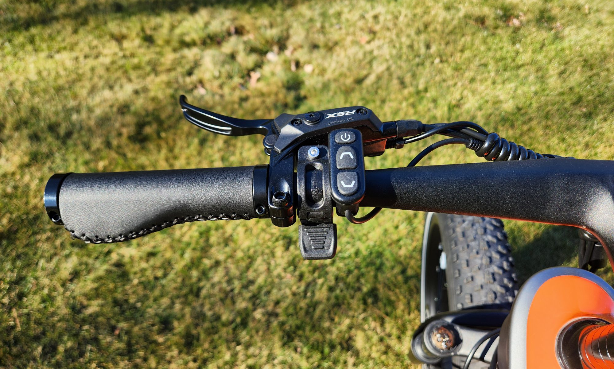HeyBike Hero e-bike handlebar left side with front brake lever, control pad, and thumb throttle.