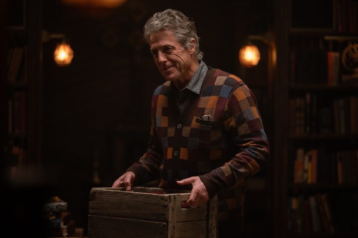 Hugh Grant holds a wooden box in Heretic.
