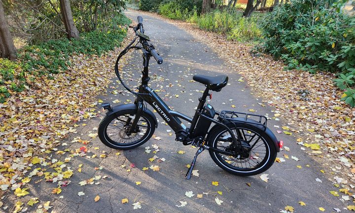 Lectric ONE parked on a leafy lane left profile.