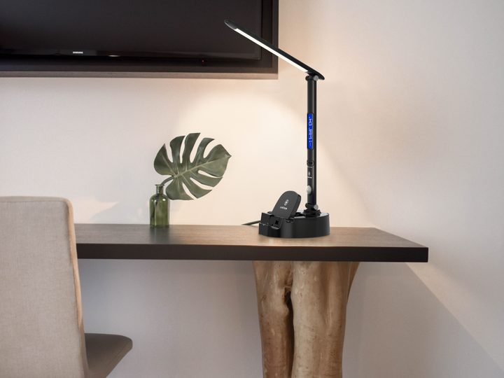 LumiCharge smart lamp on wooden table charging devices