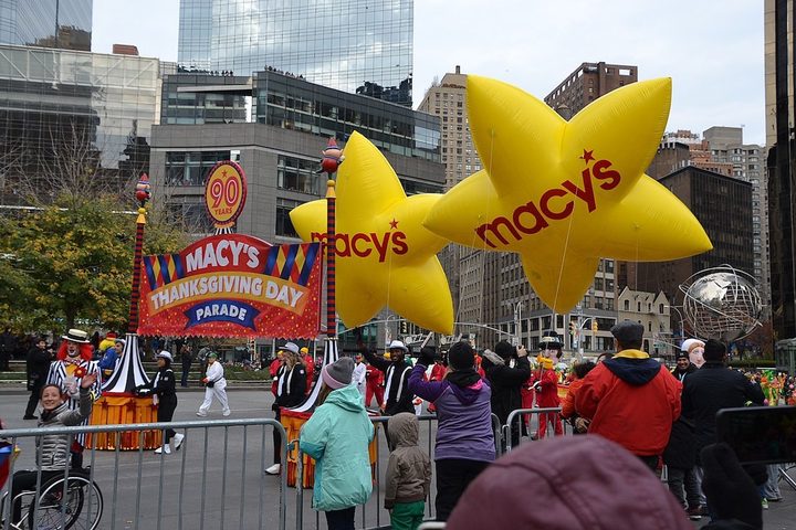 The Macy's star floats fly over the street.